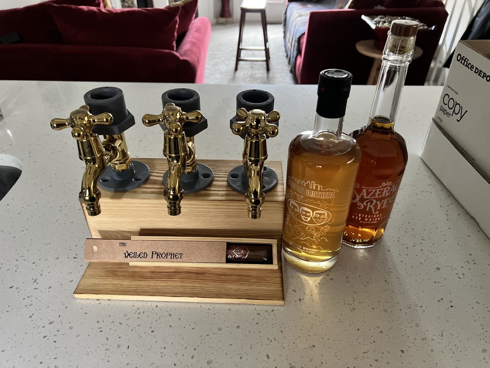 Close-up of the three-tap whiskey dispenser with Sazerac Rye and Brough Brothers Bourbon.